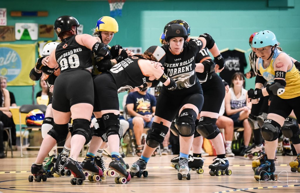 Roller derby skaters on track