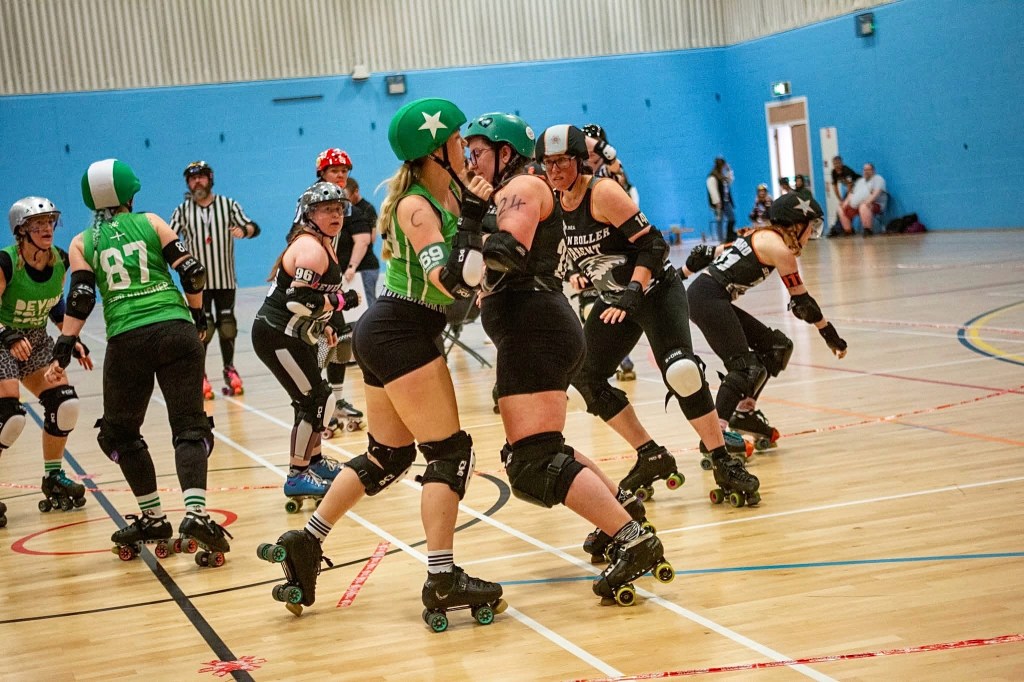Two roller derby teams on track mid game